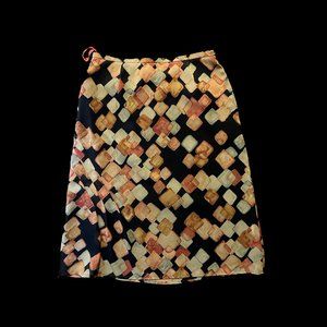 Ewanika polyester crepe skirt, black with green and rust pattern, size medium.